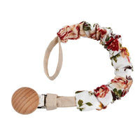 L'attache tétine en coton est blanche avec des fleurs rouges- Mon Doux Cocon