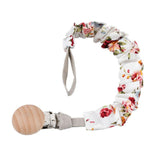 L'attache tétine en coton est blanche avec des petites fleurs roses- Mon Doux Cocon